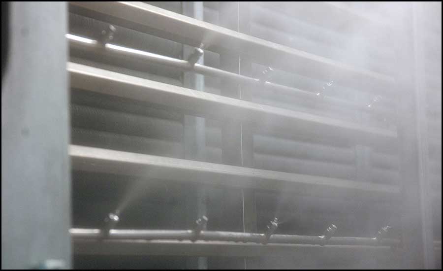 Four heat recovery units (HRUs) have fog nozzle arrays stationed inside to spray the exhaust air with fog.